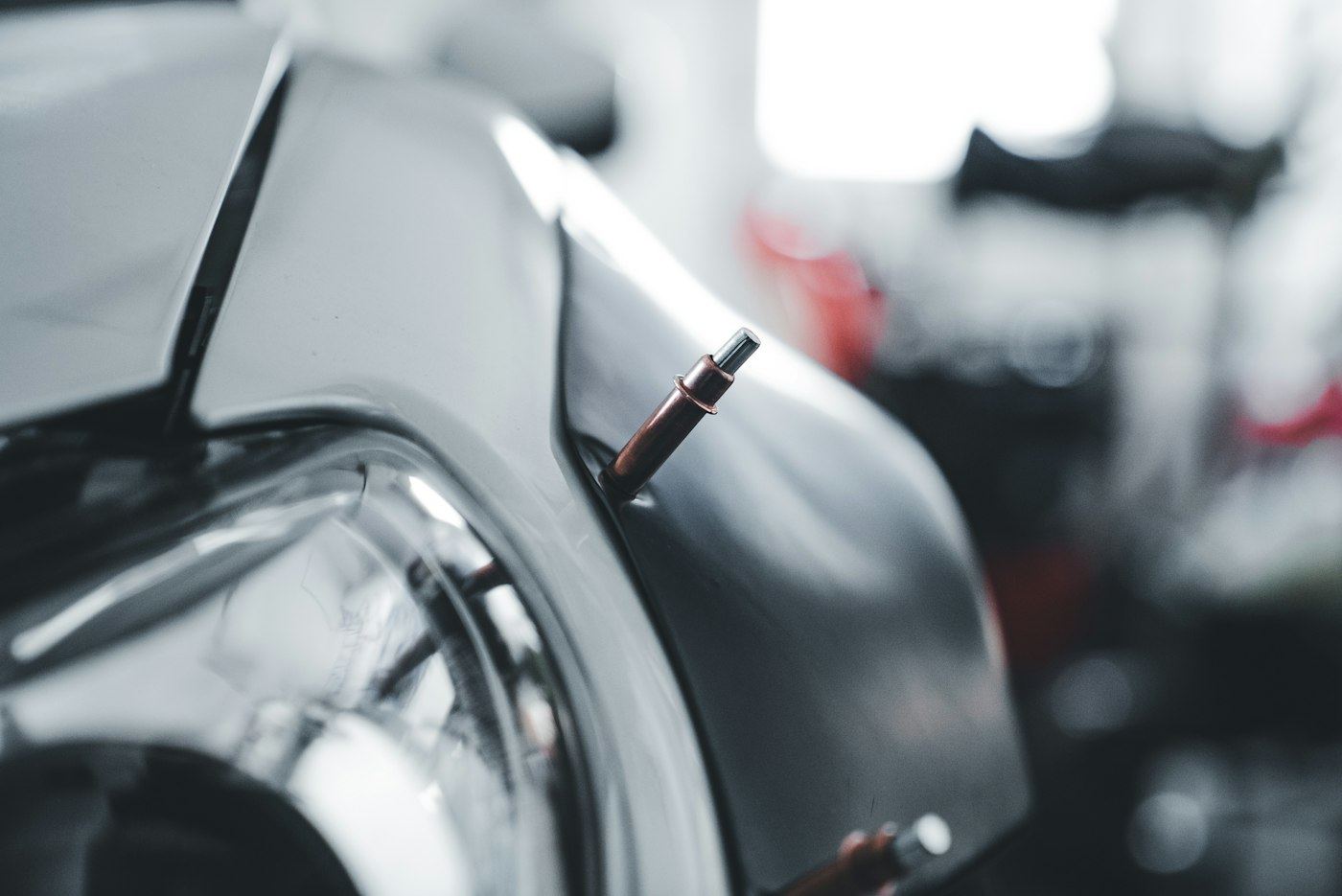 A car body being spot welded in the workshop